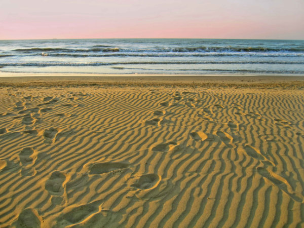 Morning empty beach and footprints on sand Morning empty beach and footprints on sand, Lido di Jesolo, Veneto, Italy